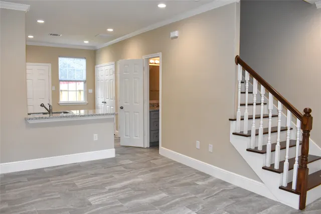 a view of an entryway with wooden floor and staircase