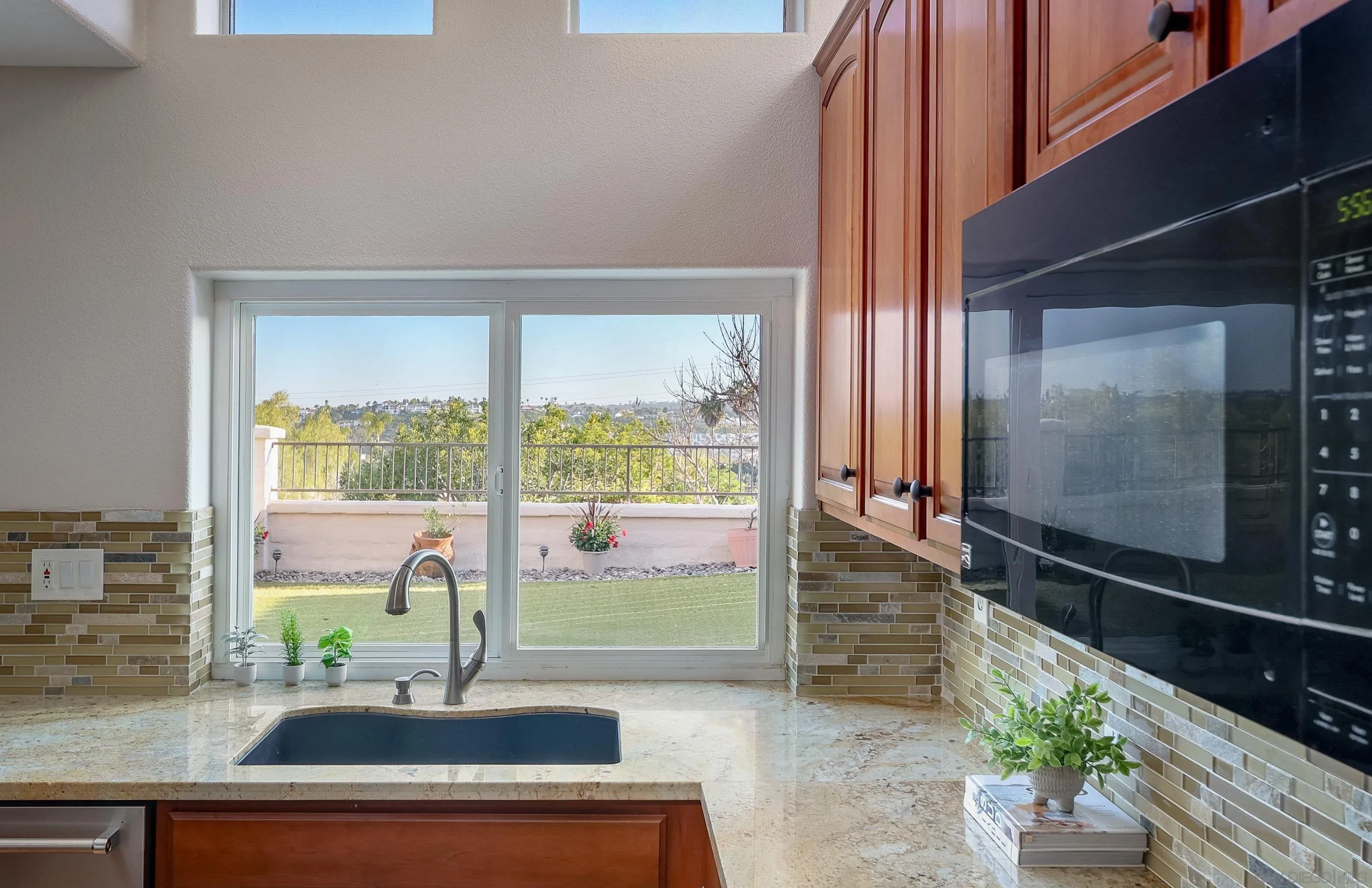 2347 Terraza Ribera Carlsbad, CA 92009 - Photo 13 of 42 a kitchen with a sink and a large window