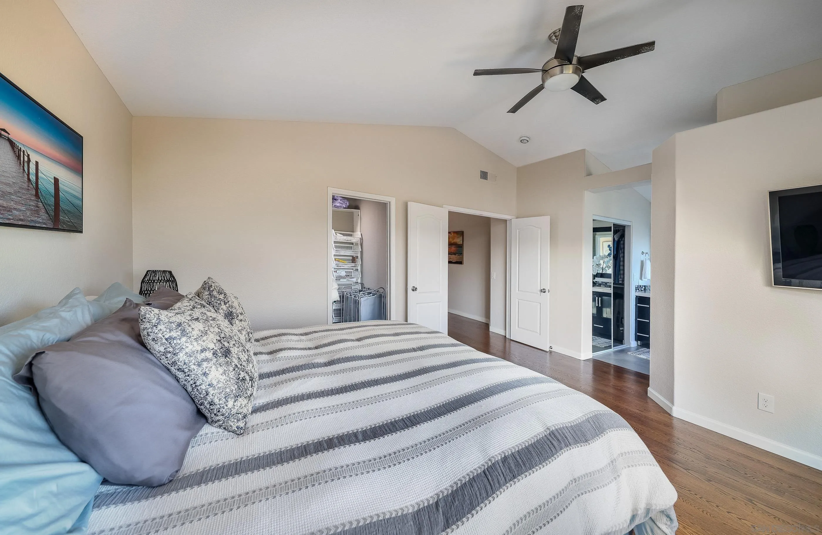 2347 Terraza Ribera Carlsbad, CA 92009 - Photo 21 of 42 a spacious bedroom with a bed and a flat screen tv