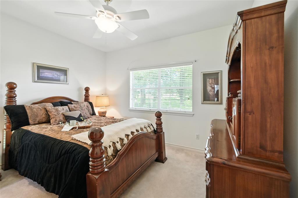 2134 Rains County Road 1402 Point, TX 75472 - Photo 18 of 26 a bedroom with a bed and a chandelier