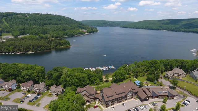 an aerial view of a house with a yard and lake view