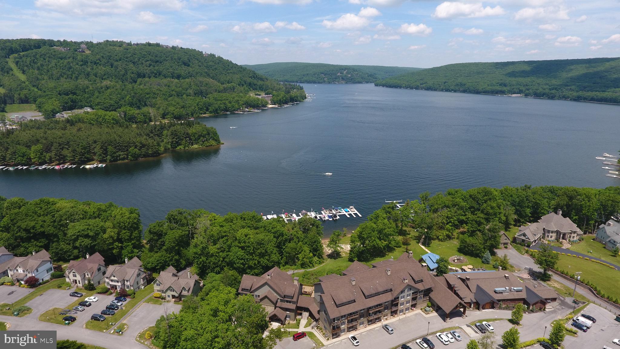 an aerial view of a house with a yard and lake view