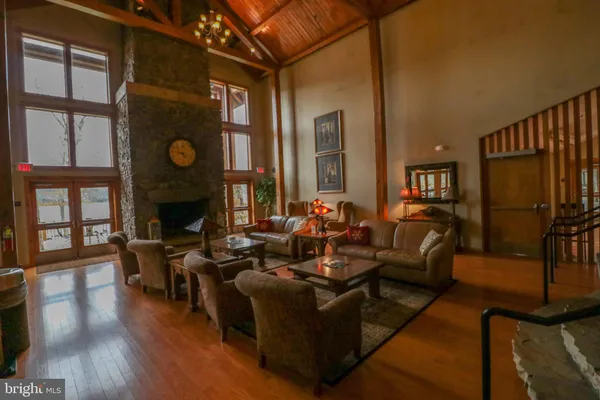 a living room with furniture a air conditioner vent and a window