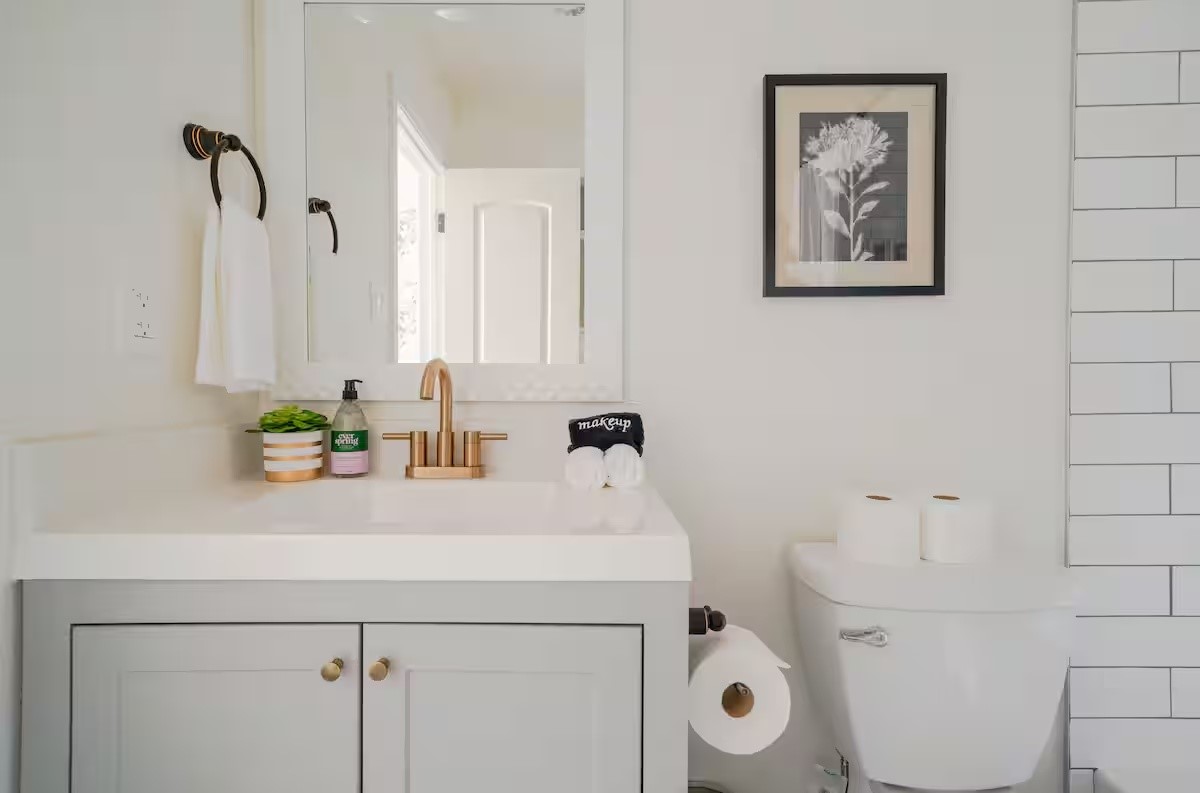 1912 Arbor Street, Unit 3 Houston, TX 77004 - Photo 11 of 24 a bathroom with a sink a toilet and a mirror