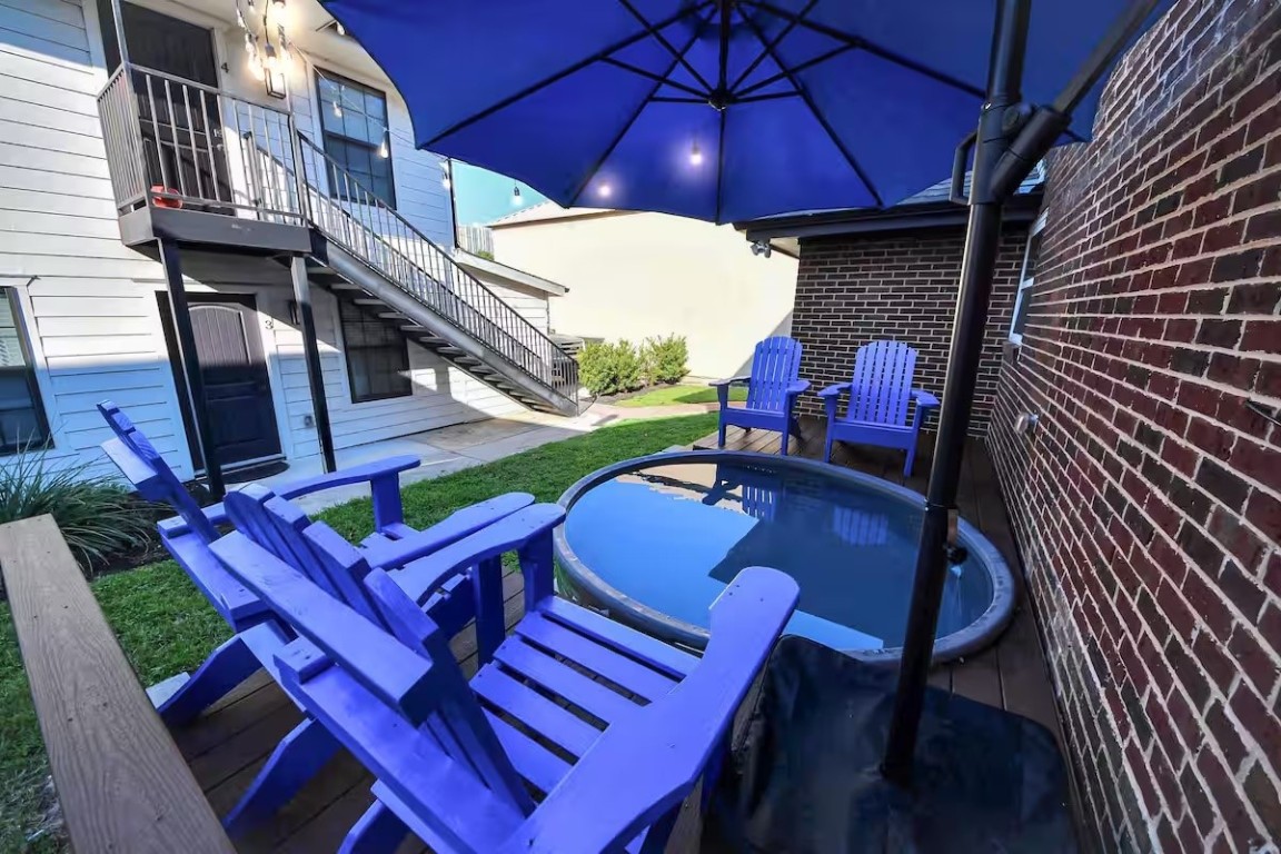 1912 Arbor Street, Unit 3 Houston, TX 77004 - Photo 18 of 24 a view of a patio with table and chairs under an umbrella