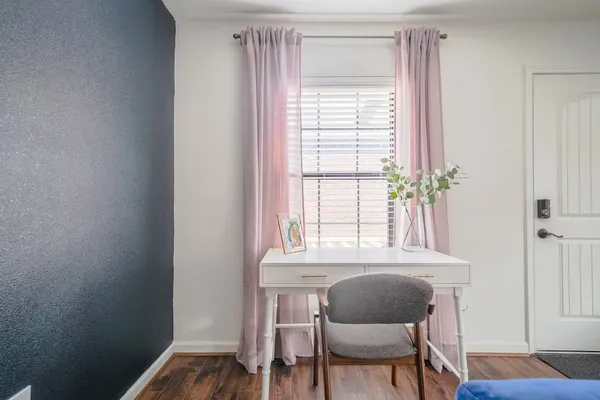 a view of a room with a window and chair