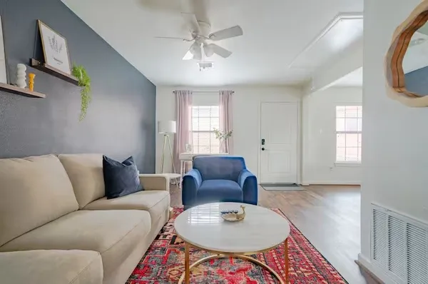 a living room with furniture and a chandelier