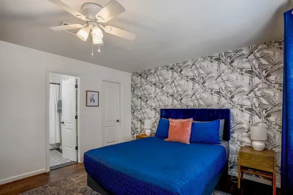 a bedroom with a bed and a chandelier