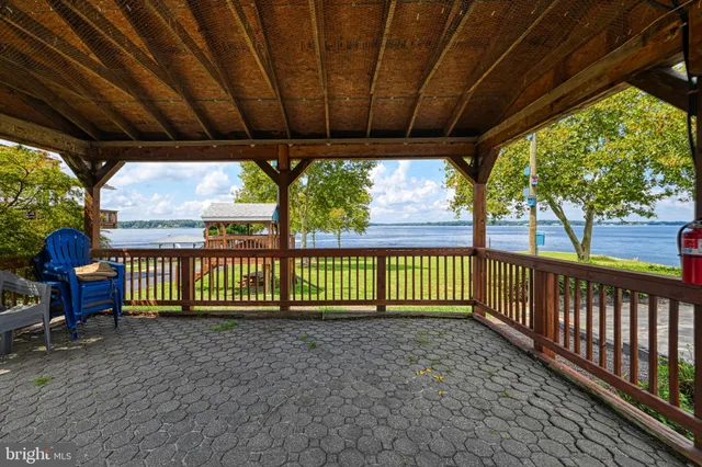 a view of a porch with wooden floor and outdoor seating