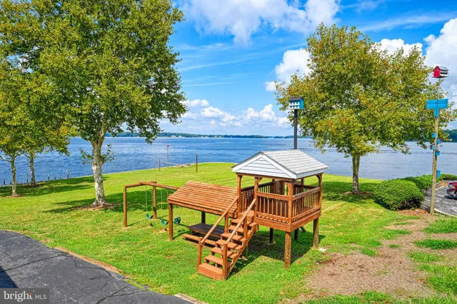 a workspace room with wooden floor a table and chairs