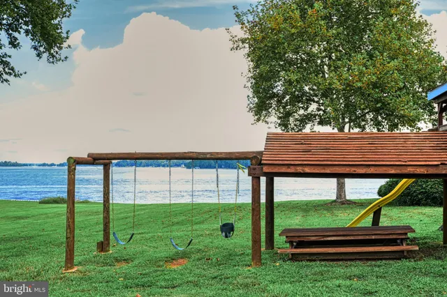 a living room with furniture a flat screen tv and a large window