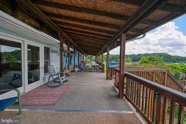 a bedroom with a bed and a dresser with mirror