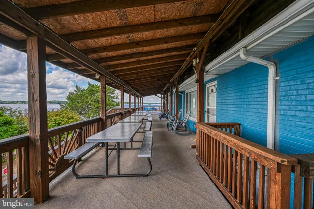 a bedroom with a balcony a bed and a window