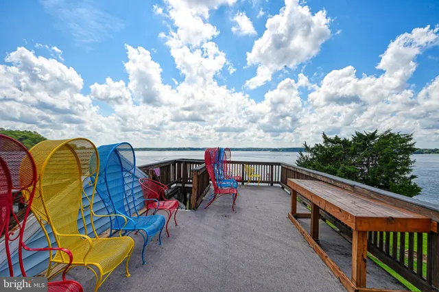 a bedroom with a bed and a lamp on dresser