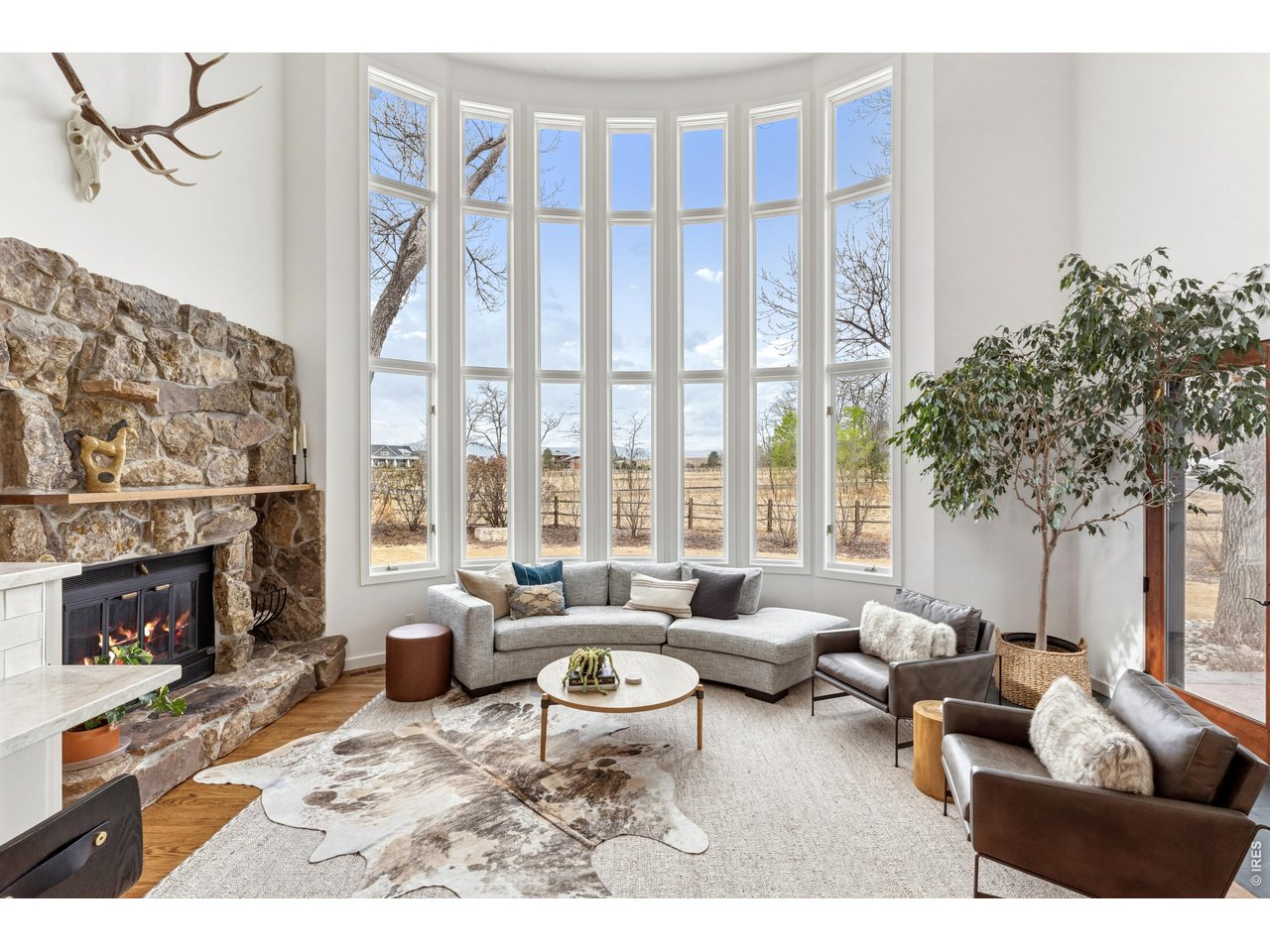 9421 Gunbarrel Ridge Road Boulder, CO 80301 - Photo 16 of 50 a living room with furniture large window and a fireplace