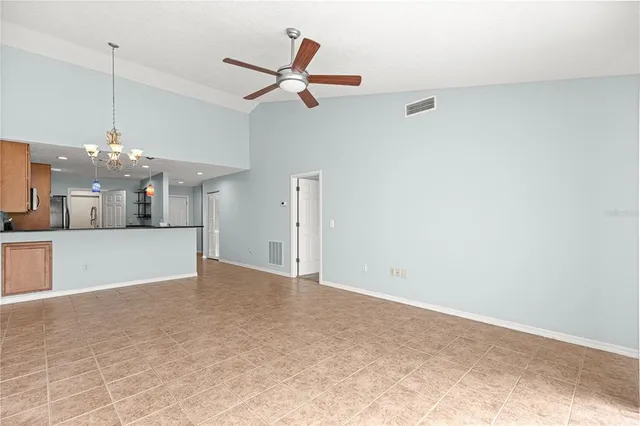 a view of a kitchen with a sink and chandelier fan