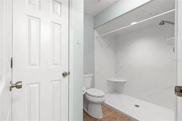 a white toilet sitting next to a bathroom sink