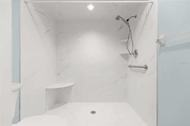 a bathroom with a bath tub with a shower