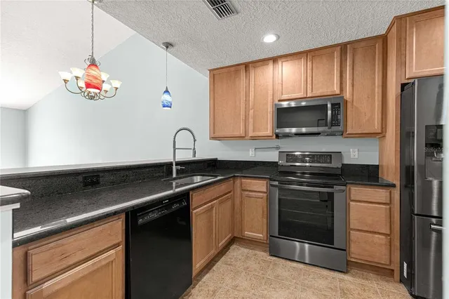 a kitchen with a sink stove and microwave