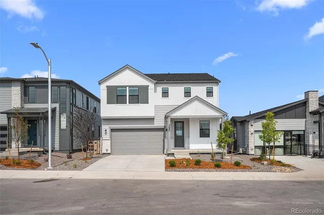 a view of a house with a patio and a yard