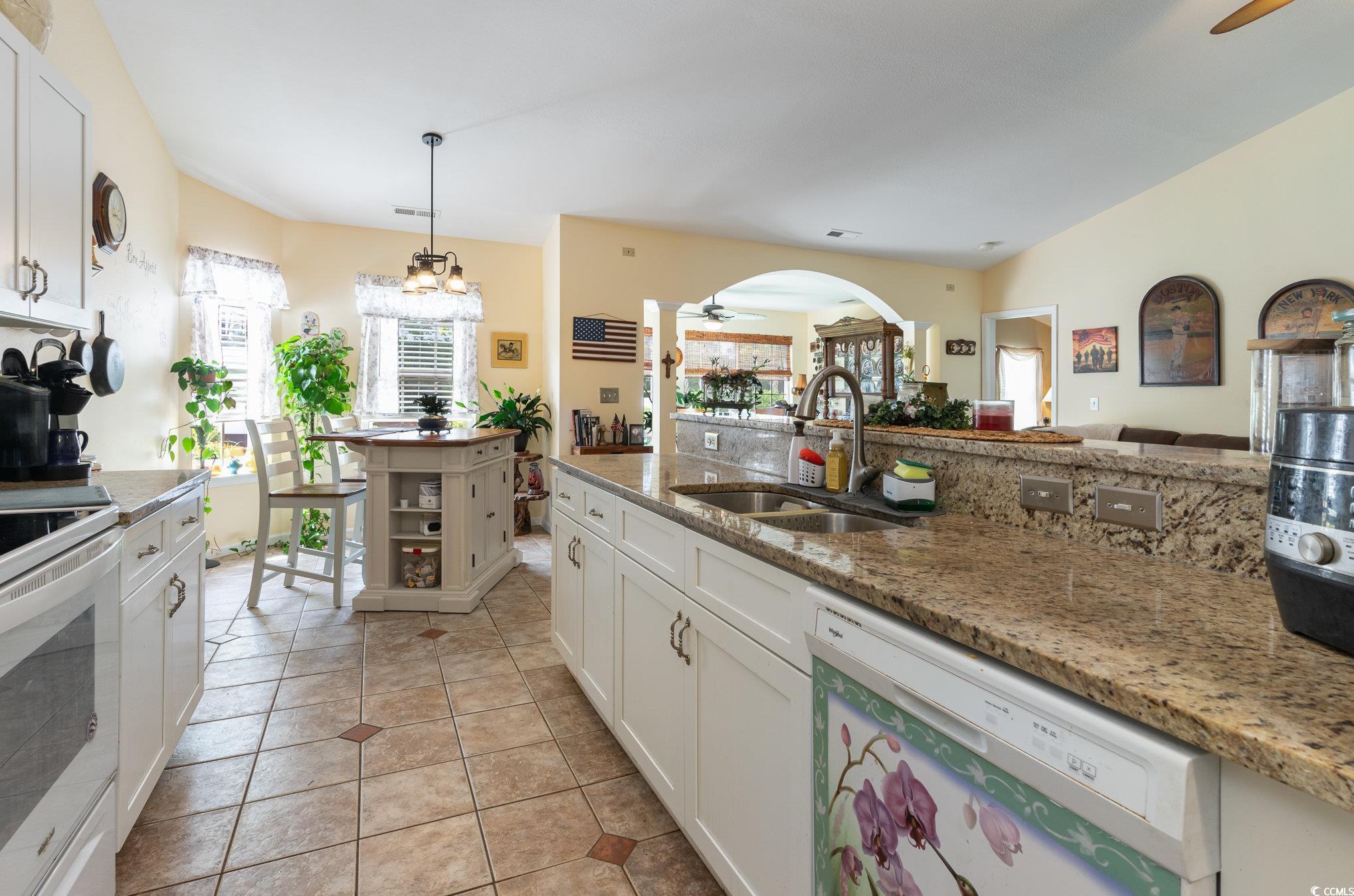 Kitchen featuring light tile patterned floors, cei