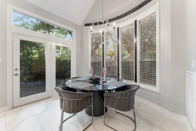 a dining room with furniture and window