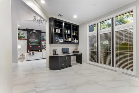 a view of living room kitchen with stainless steel appliances granite countertop cabinets and window