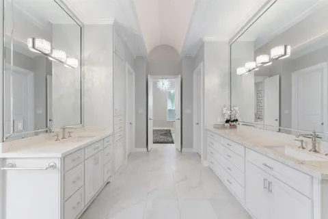 a bathroom with a sink double vanity and a mirror