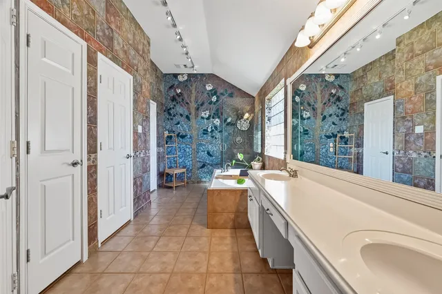 a large white kitchen with a large window