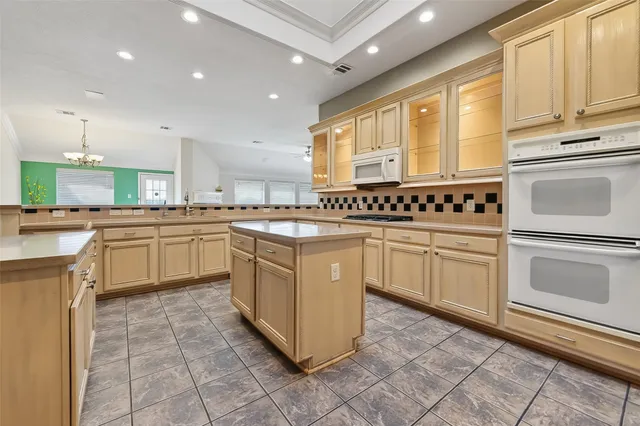 a kitchen with a stove sink and cabinets