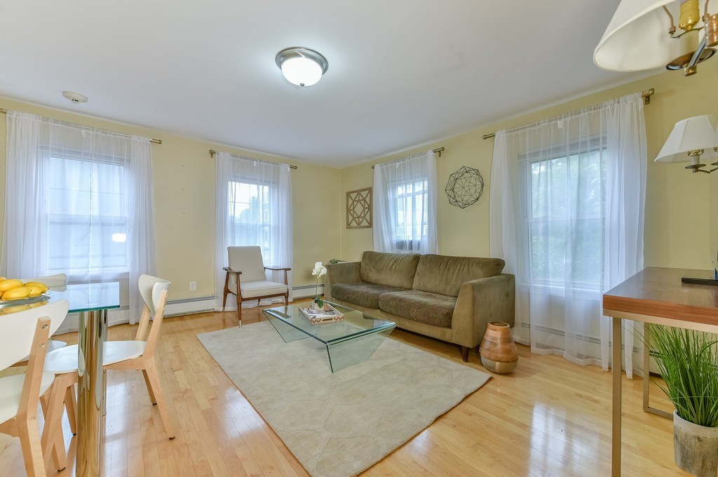 95 Second Street, Unit 3 Cambridge, MA 02141 - Photo 3 of 13 a living room with furniture and a window