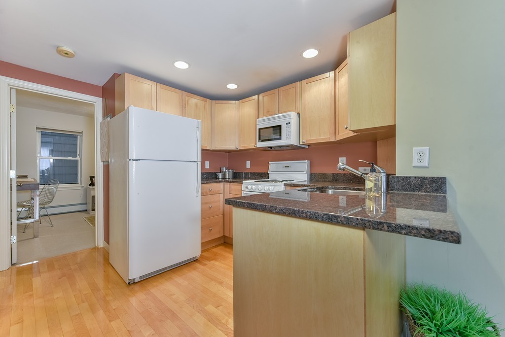 95 Second Street, Unit 3 Cambridge, MA 02141 - Photo 7 of 13 a kitchen with stainless steel appliances granite countertop a refrigerator a stove and a sink