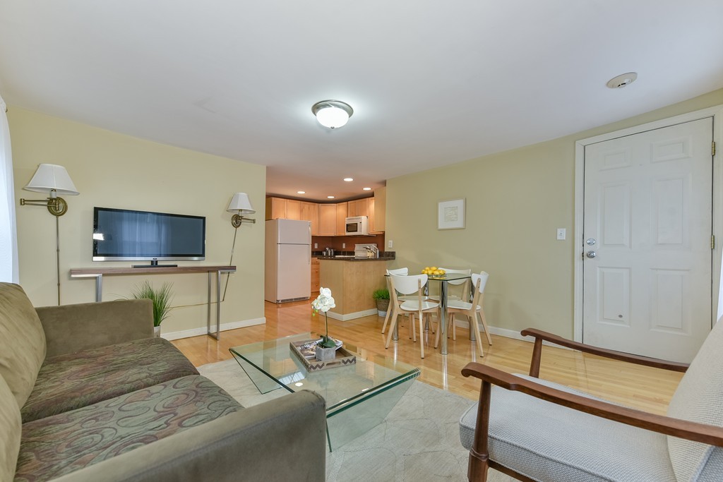 95 Second Street, Unit 3 Cambridge, MA 02141 - Photo 9 of 13 a living room with furniture and a flat screen tv