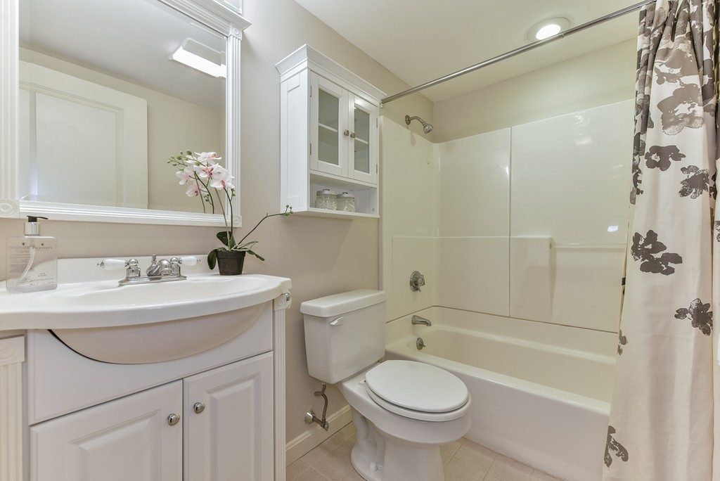 95 Second Street, Unit 3 Cambridge, MA 02141 - Photo 10 of 13 a bathroom with a sink toilet a mirror and shower