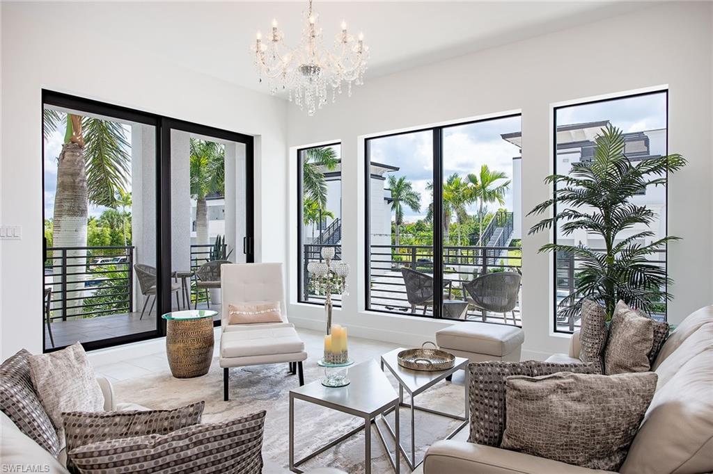 1111 Central Avenue, Unit 207 Naples, FL 34102 - Photo 1 of 18 a living room with furniture and a large window