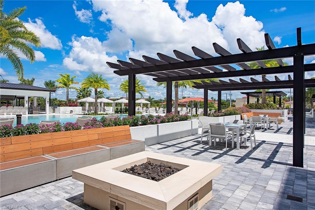 1111 Central Avenue, Unit 207 Naples, FL 34102 - Photo 14 of 18 a view of a patio with a table and chairs