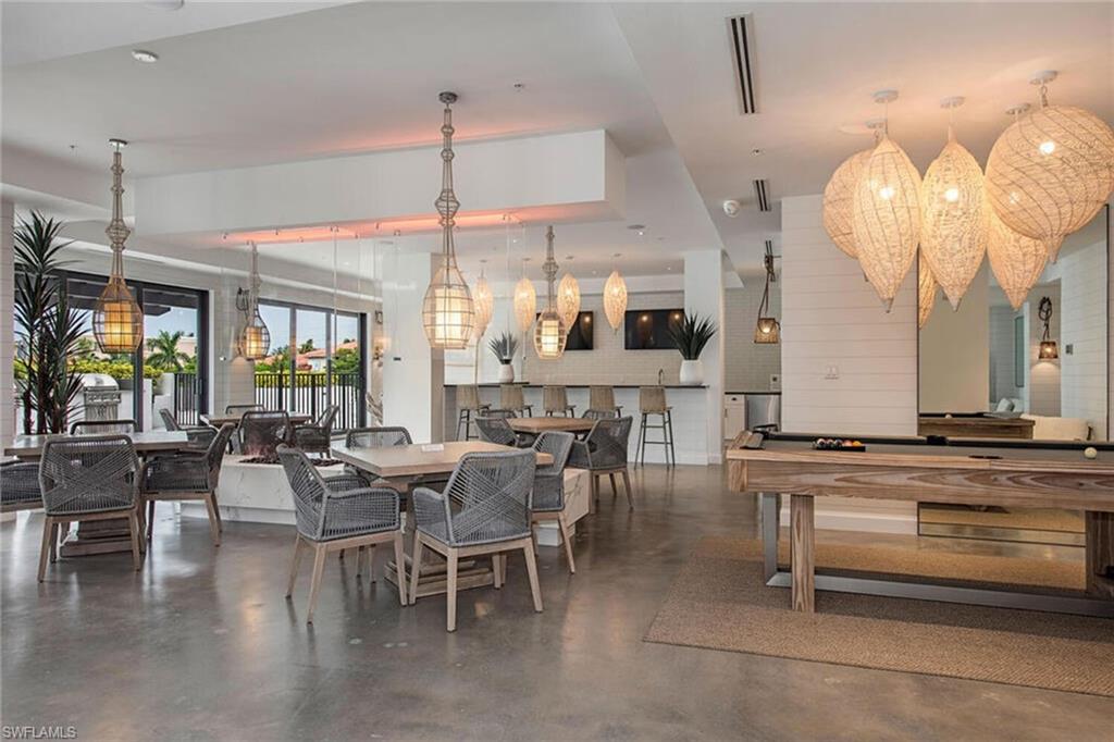 1111 Central Avenue, Unit 207 Naples, FL 34102 - Photo 16 of 18 a view of a dining room with furniture window and wooden floor