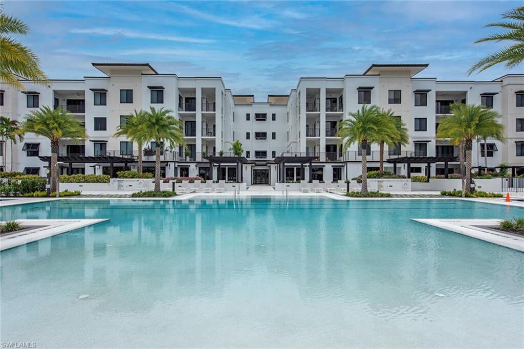 1111 Central Avenue, Unit 207 Naples, FL 34102 - Photo 18 of 18 a view of house with swimming pool and outdoor seating