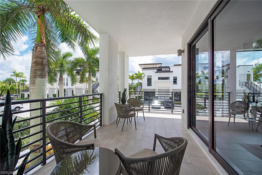 1111 Central Avenue, Unit 207 Naples, FL 34102 - Photo 2 of 18 a dining room with furniture and wooden floor