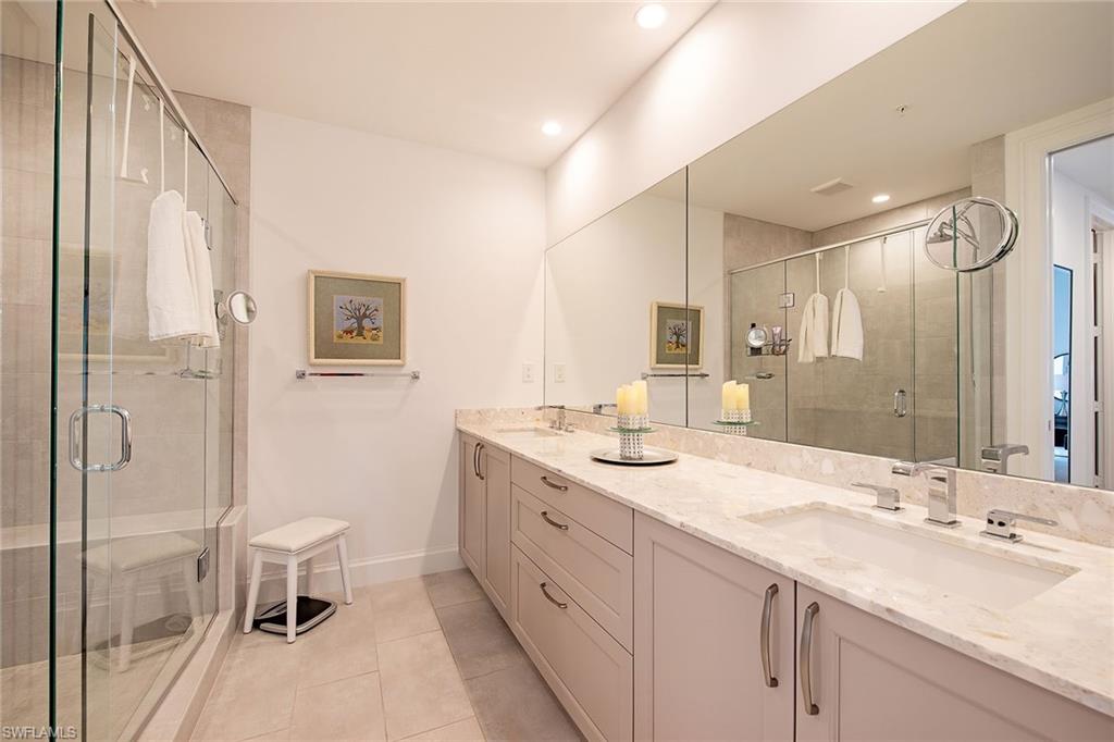 1111 Central Avenue, Unit 207 Naples, FL 34102 - Photo 9 of 18 a bathroom with a double vanity sink toilet and shower