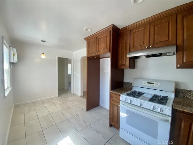 a kitchen with stainless steel appliances granite countertop a refrigerator and a stove