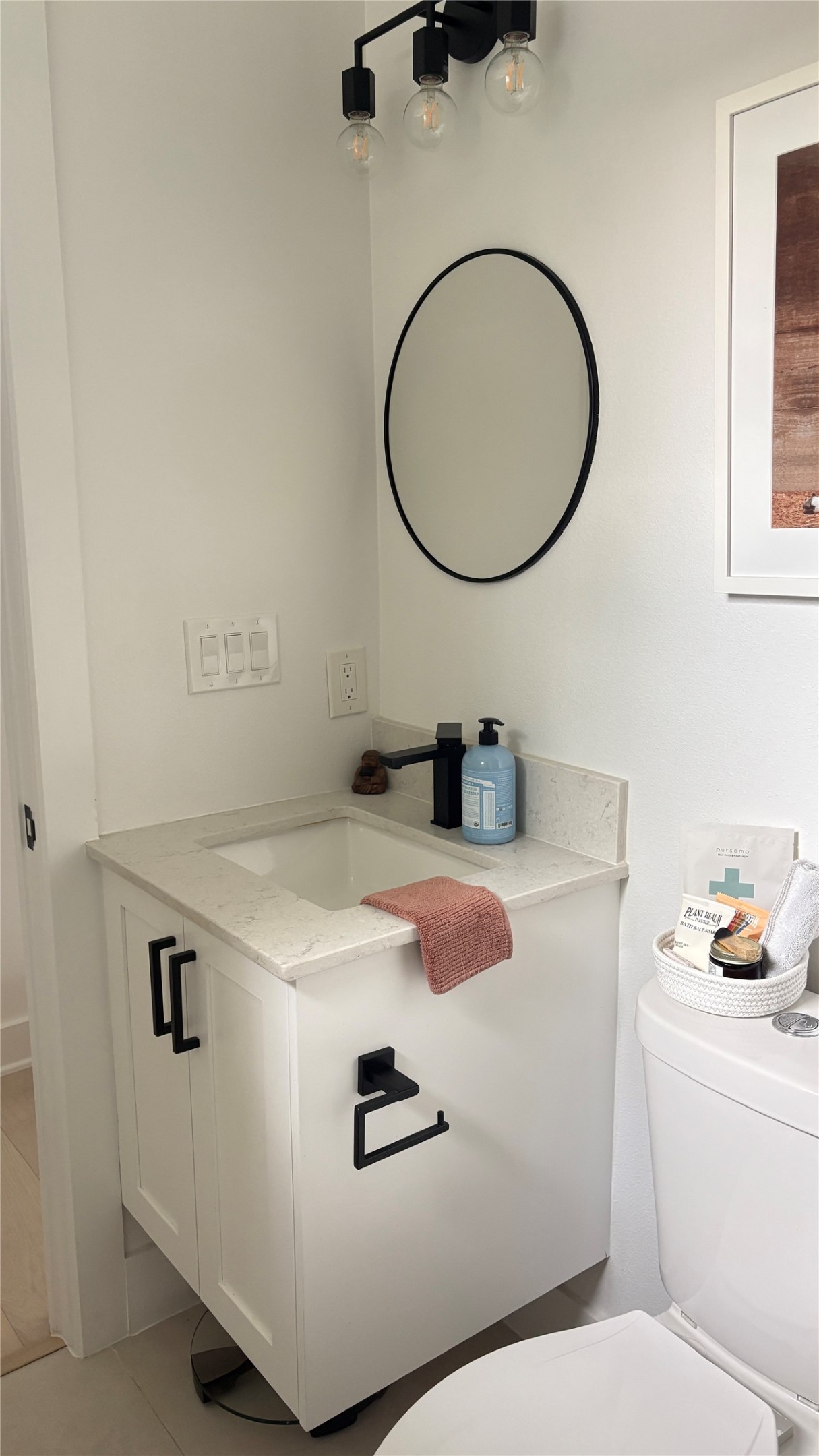 1816 Adina Street, Unit 2 Austin, TX 78721 - Photo 19 of 25 White vanity with a light-toned countertop, an integrated rectangular sink, and a matte black faucet