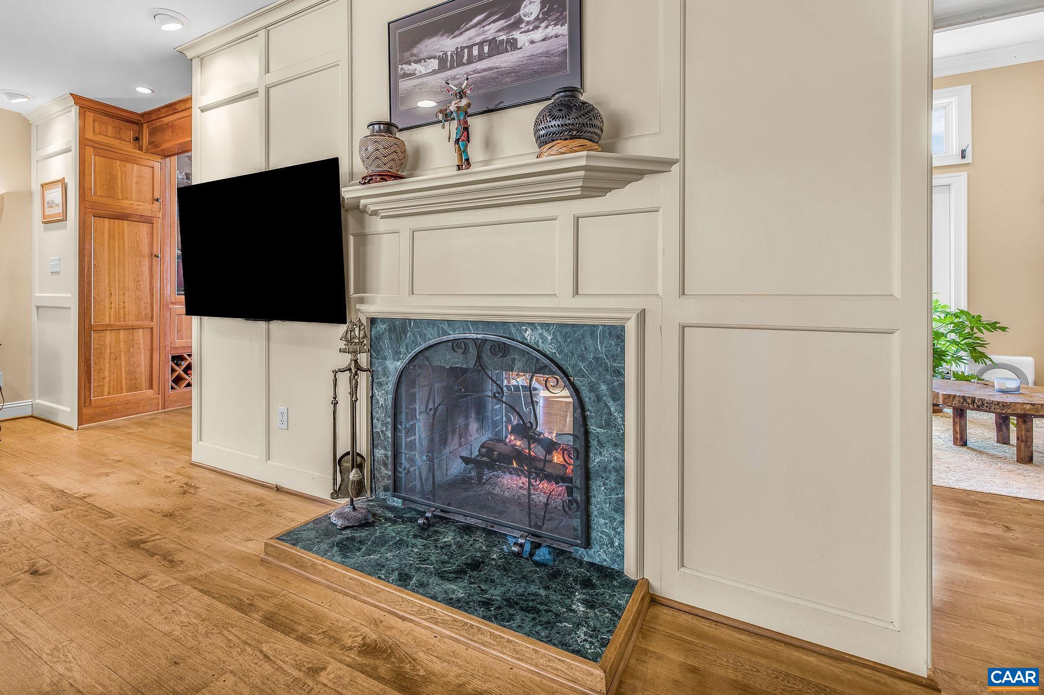 987 Rodes Farm Drive Nellysford, VA 22958 - Photo 12 of 74 a living room with a fireplace and a flat screen tv