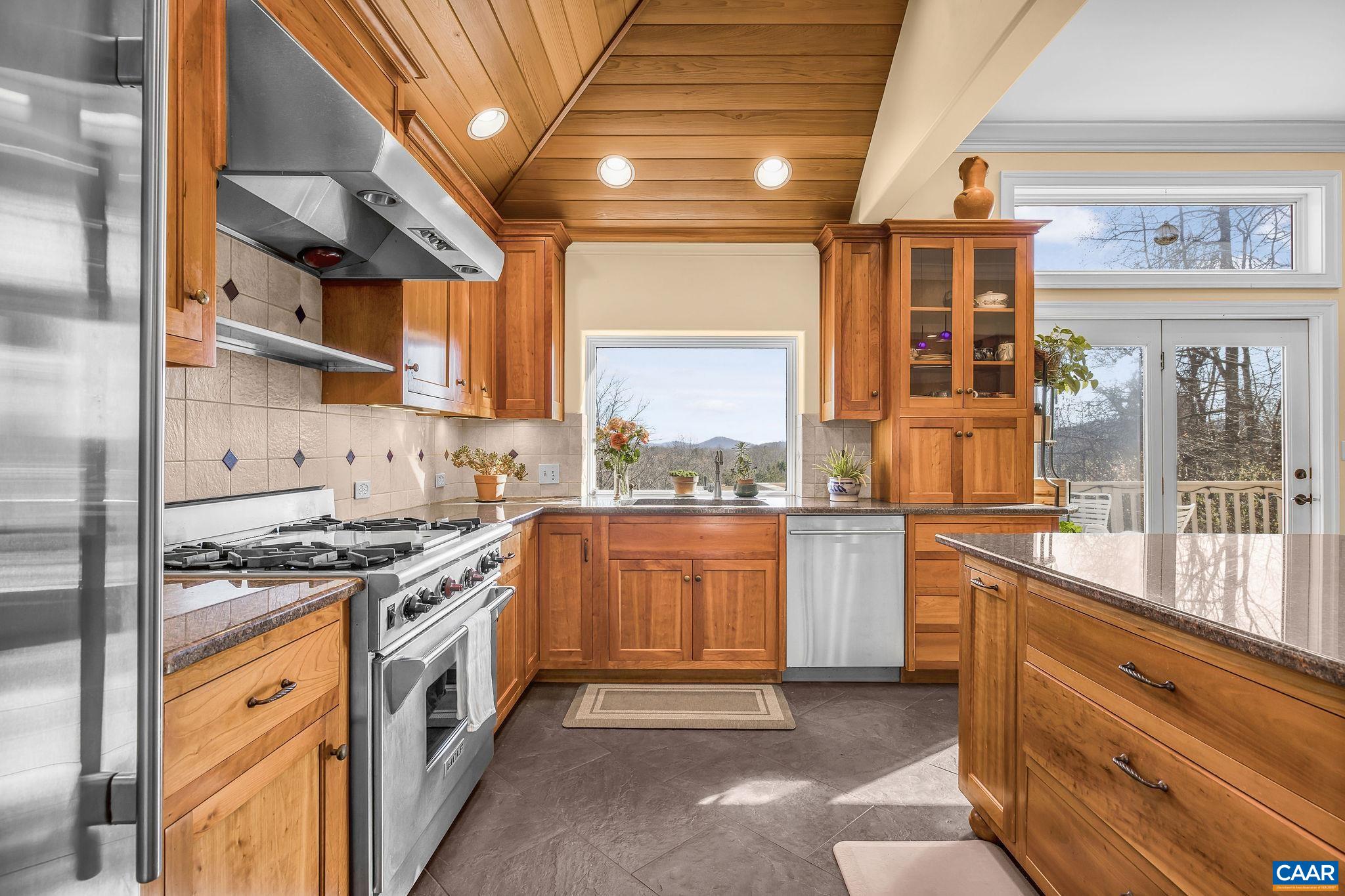 987 Rodes Farm Drive Nellysford, VA 22958 - Photo 22 of 74 a kitchen with stainless steel appliances granite countertop a stove and a refrigerator