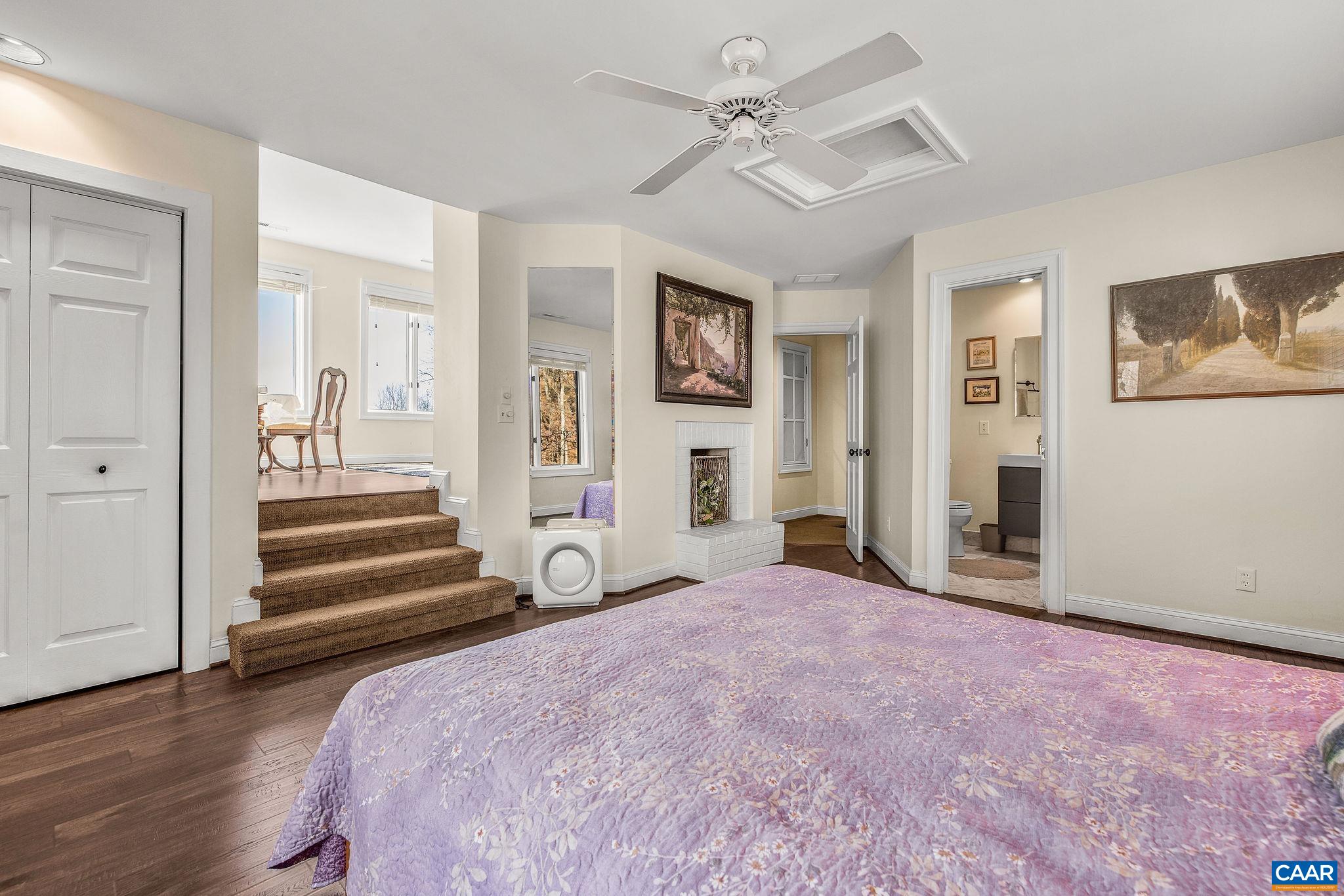 987 Rodes Farm Drive Nellysford, VA 22958 - Photo 32 of 74 a view of a livingroom with wooden floor and a ceiling fan