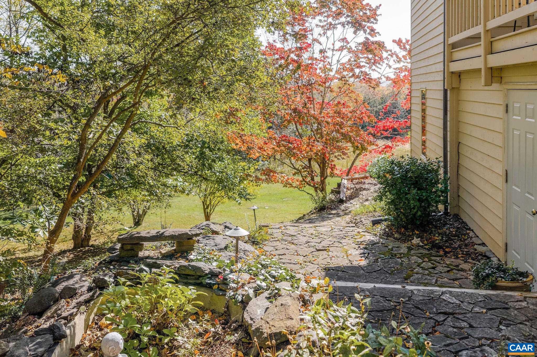 987 Rodes Farm Drive Nellysford, VA 22958 - Photo 54 of 74 a view of a yard with plants and flowers