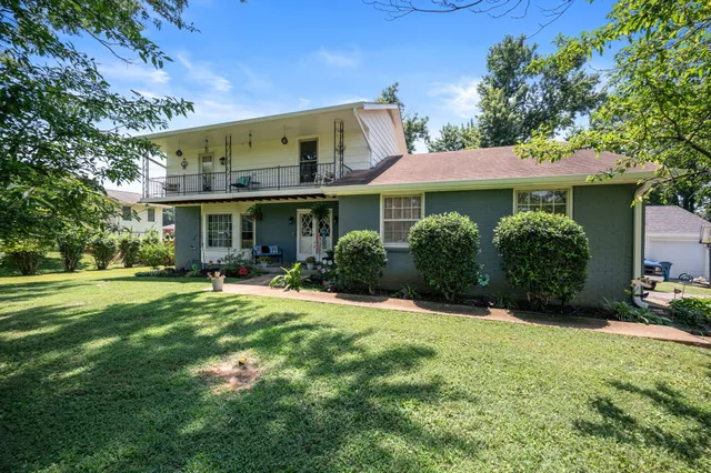 a swimming pool with lots of tress in front of it