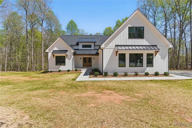 a view of a house with pool and chairs