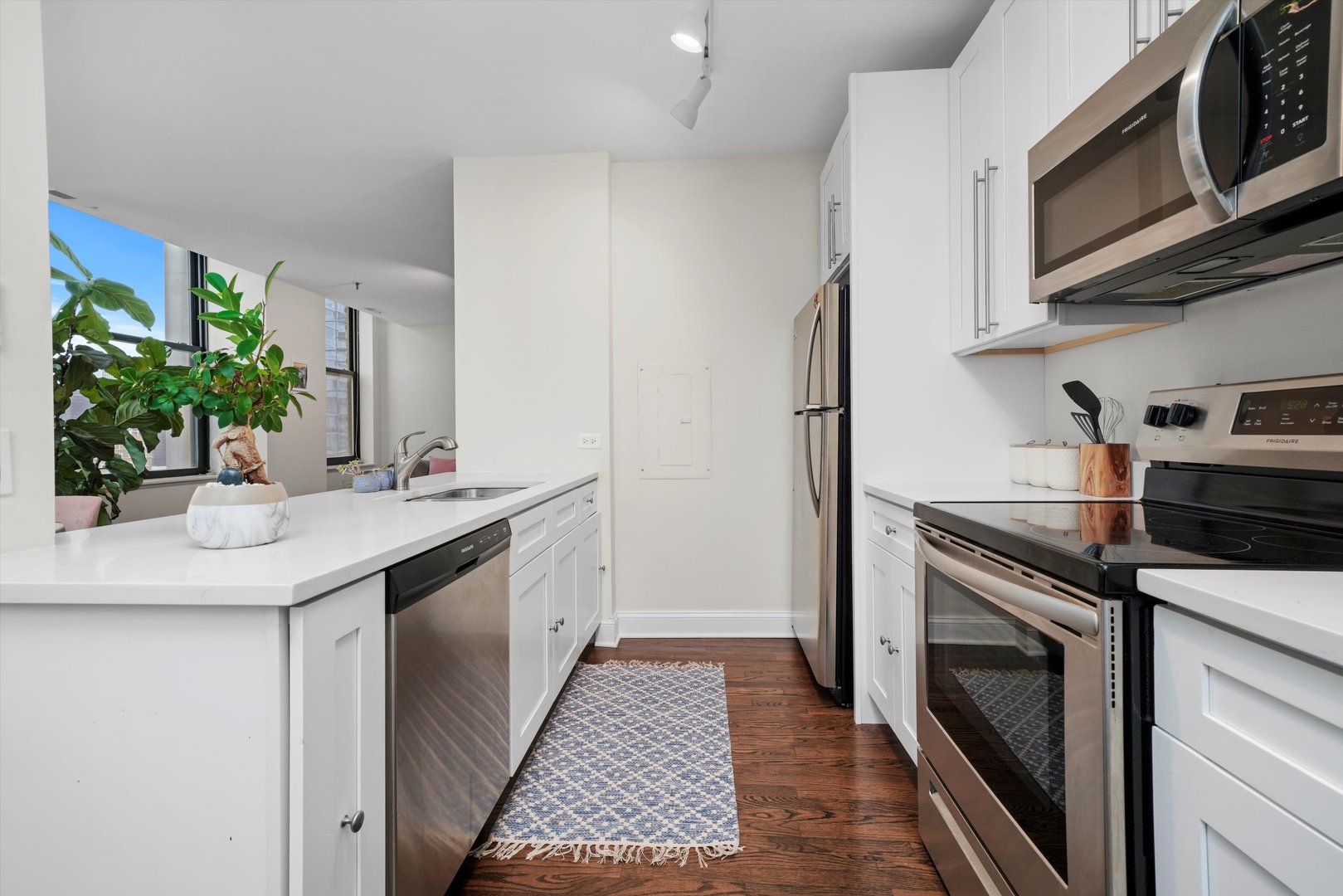 780 South Federal Street, Unit 1207 Chicago, IL 60605 - Photo 13 of 22 a kitchen with stainless steel appliances granite countertop a sink and stove top oven