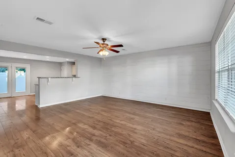 wooden floor in an empty room with a window